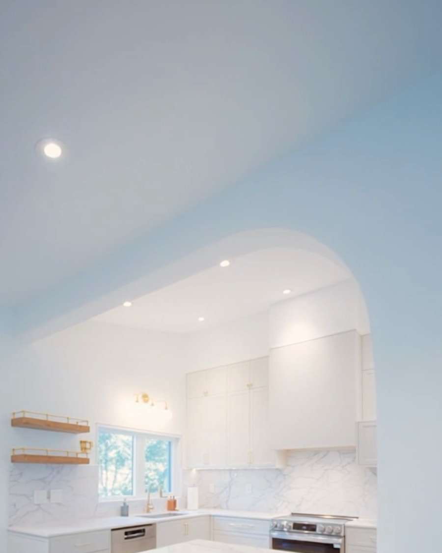 After: the same wall opened into a wide arch onto the new kitchen.